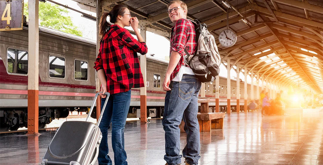 Zwei Personen an einem Bahnhof mit einem Koffer von LPB